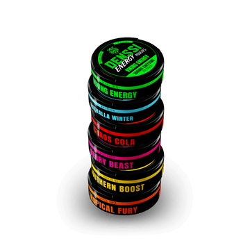 Denssi Energy Pouches Variety Pack OG Stack image with all 6 Denssi energy pouch flavors stacked. Tropical Fury (orange) at the bottom, Southern Boost (yellow), Berry Beast (pink), Valhalla winter (blue), chaos cola (red), and Viking energy green) on a transparent background 